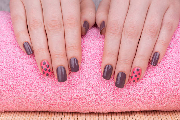 Mauve pink polka dot nail design